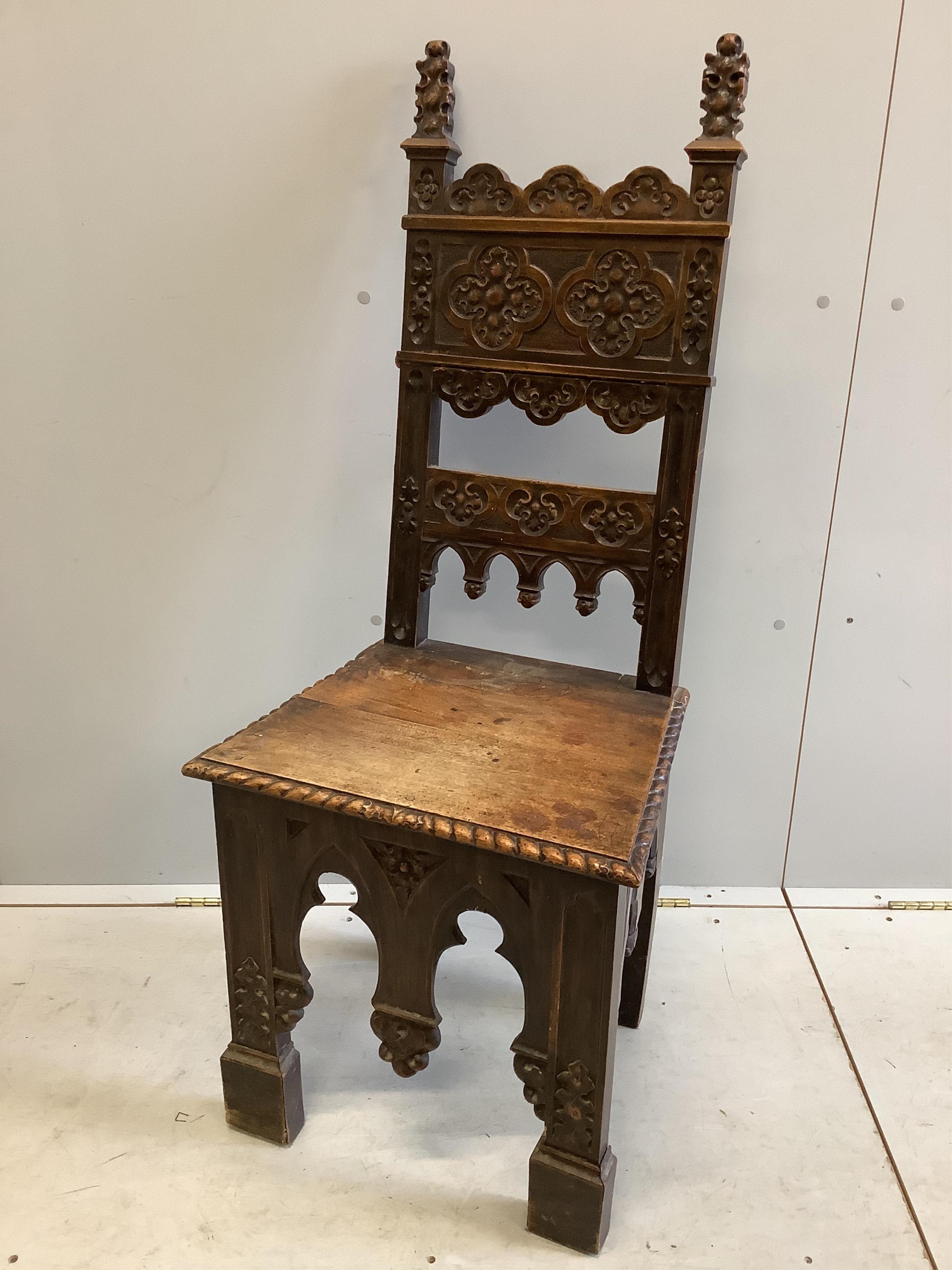 A pair of 19th century Italian walnut hall chairs, width 48cm, depth 39cm, height 118cm. Condition - fair